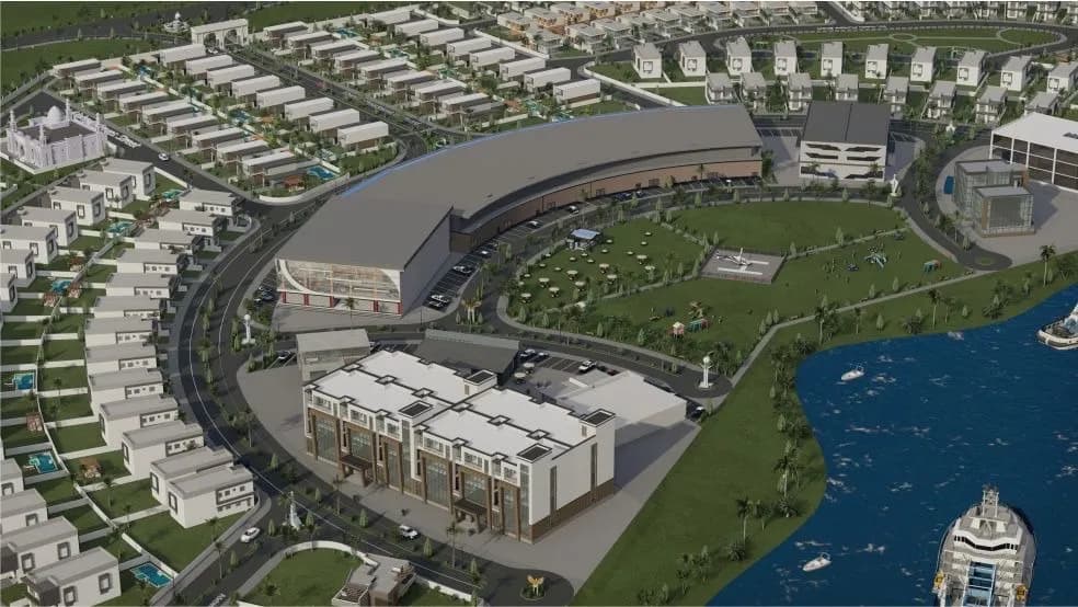 Aerial view of a waterfront development with townhouses, green spaces and a marina
